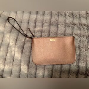Kate Spade Laurel Way Tinie Leather Wristlet in a metallic Rose Gold